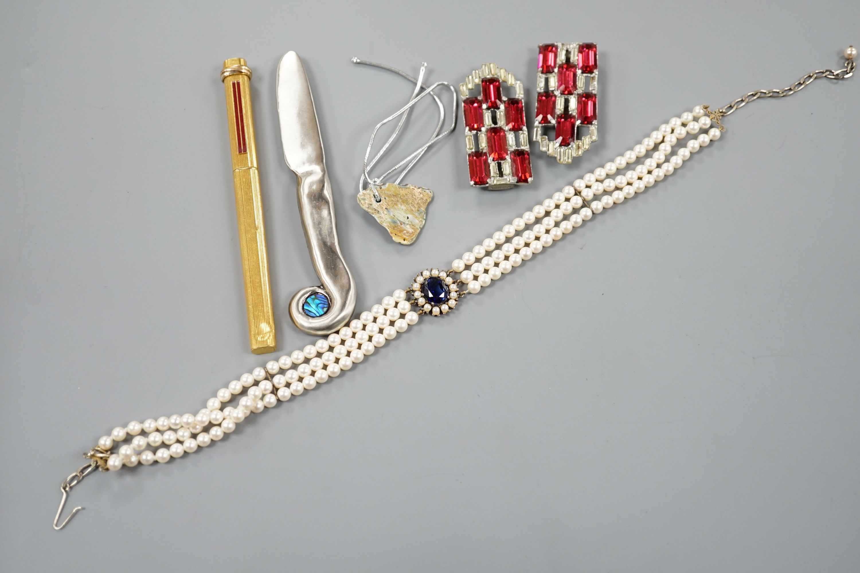A Cartier gold plated end red enamel ball point pen and minor costume jewellery.